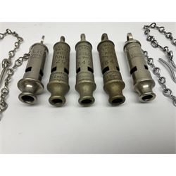 Three Hull City Police 'Metropolitan' whistles by J. Hudson 13 Barr Street Birminham, each with impressed collar number; another 'Metropolitan' police whistle with chain; and an ARP whistle by Hudson & Co with chain (5)