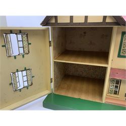 1950s Tri-ang large wooden doll's house of double fronted Tudor style with painted faux stucco walls, simulated tiled pitched roof and opening tin-plate windows, the double hinged front opening to reveal four rooms on two floors with staircase and landing and integral garage, wired for electric lighting L86cm D31cm H50cm; together with large quantity of well-made wooden furniture for lounge, dining room, kitchen, bedrooms and bathroom (bath labelled Dol-Toi), three dolls, household accessories and plastic table wares etc