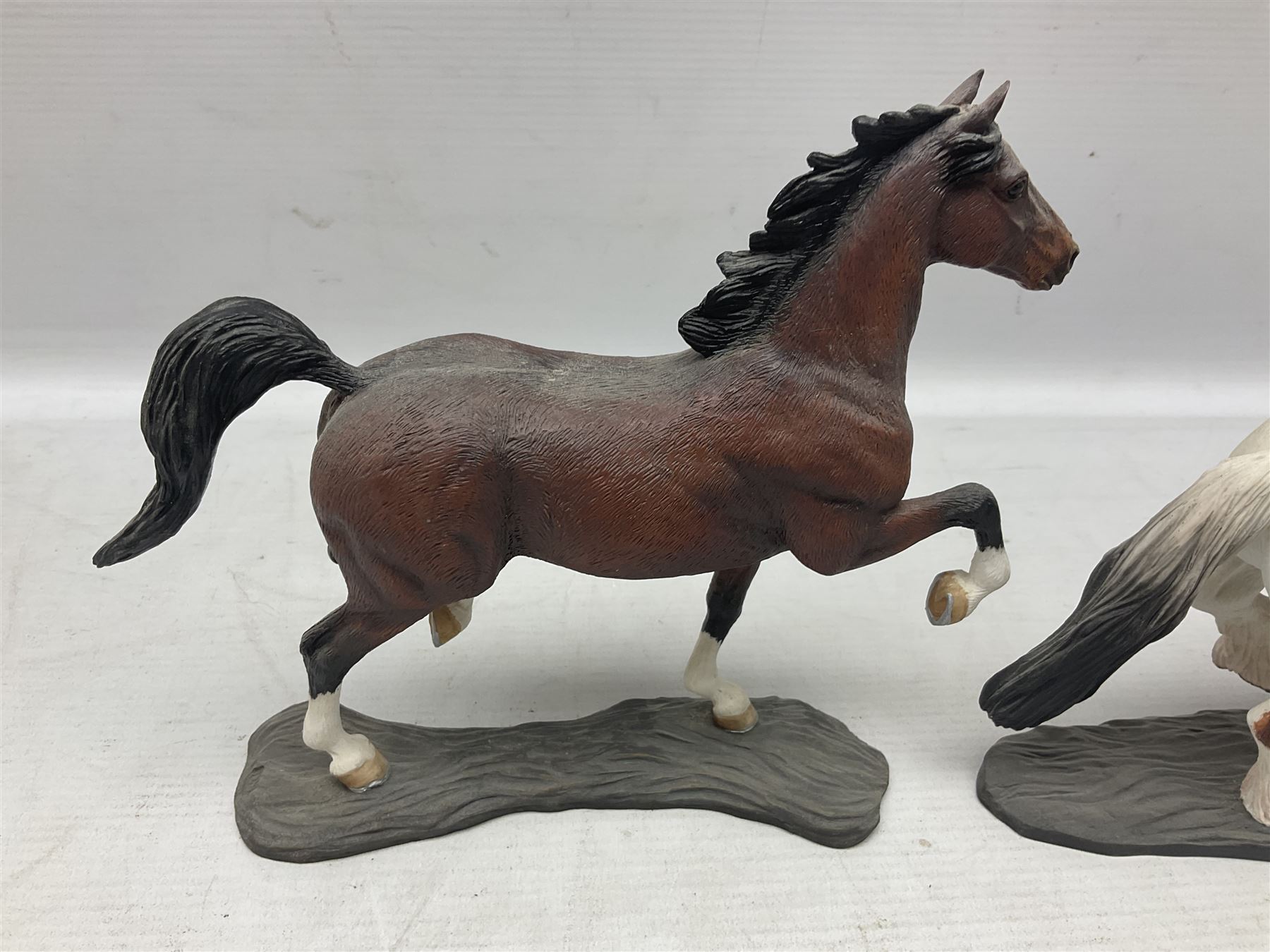 Seven Border Fine Arts figures, comprising Clydesdale Mare & Foal A0187, Highland Mare & Foal A2691 and five horses from the Action Horses series 