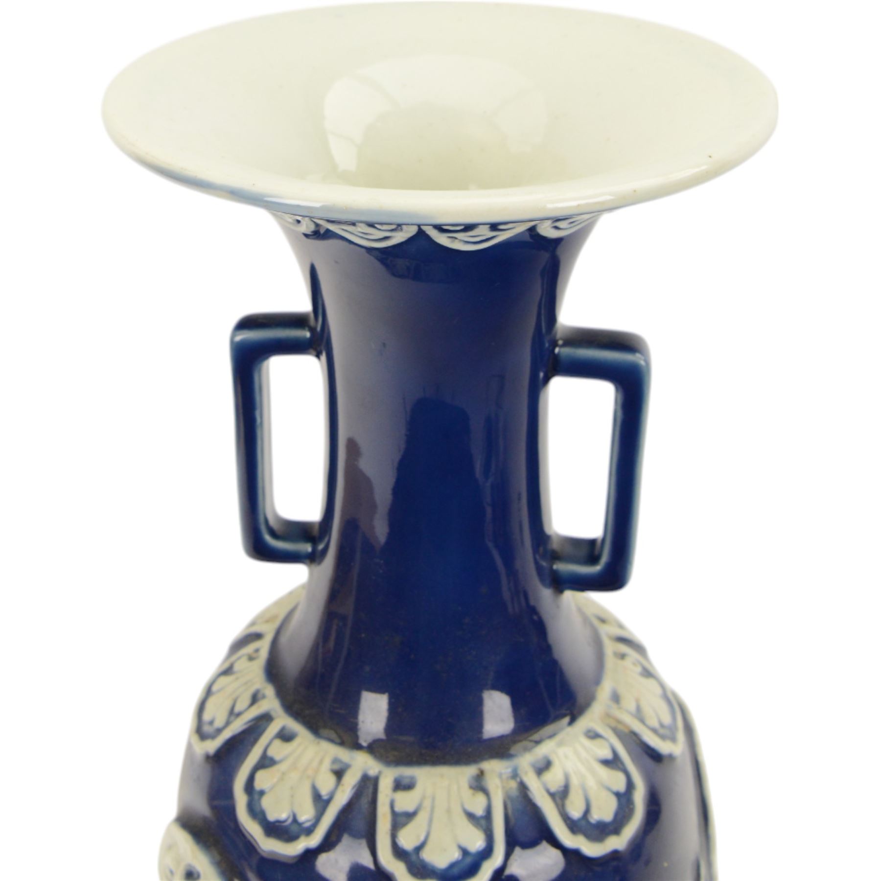 Chinses twin handled blue and white vase, decorated in relief with dragons amongst clouds upon a blue ground, H58cm 