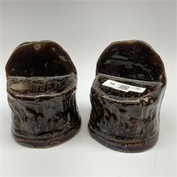 A pair of treacle glaze sash window rests, possibly Rockingham, modelled in the form of lion heads, each approximately H12.5cm.
