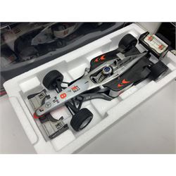 Four Minichamps 1:18 scale die-cast racing cars - Williams F1 Team BMW FW26 R. Schumacher; McLaren Mercedes MP4-12 D. Coulthard; McLaren Mercedes MP4-13 M. Hakkinen; and Formel 1 Jordan peugeot EJR 195 E. Irvine; all boxed (4)
