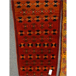  Persian style ochre ground rug, repeating border (195cm x 106cm), a red ground Turkish rug and two others  
