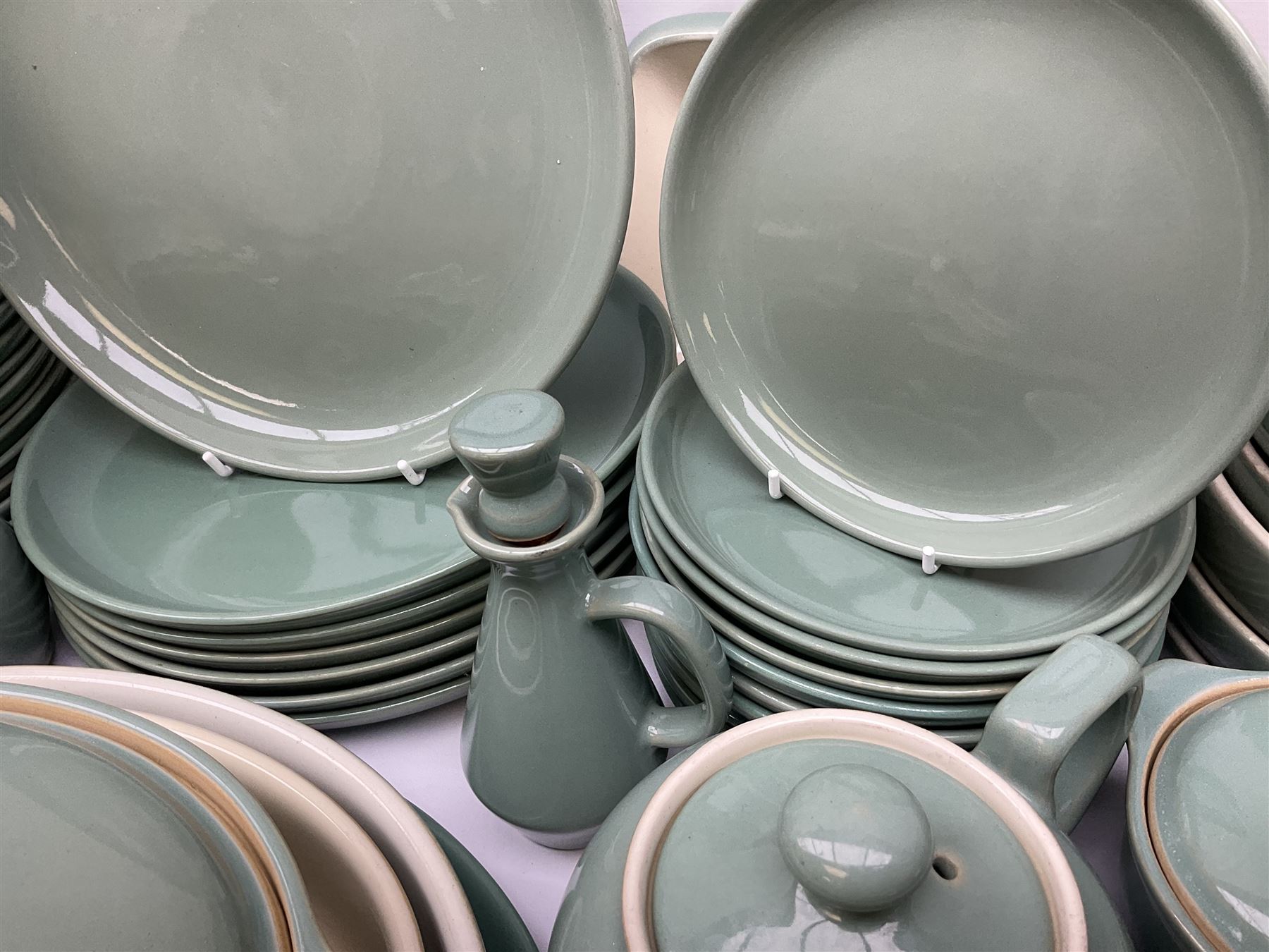 Denby Manor Green pattern part tea and dinner service, to include seven dinner plates, thirteen side plates, ten dessert plates, two oval dishes of various sizes, four cups and saucers, seven bowls with covers, two teapots etc (74)  