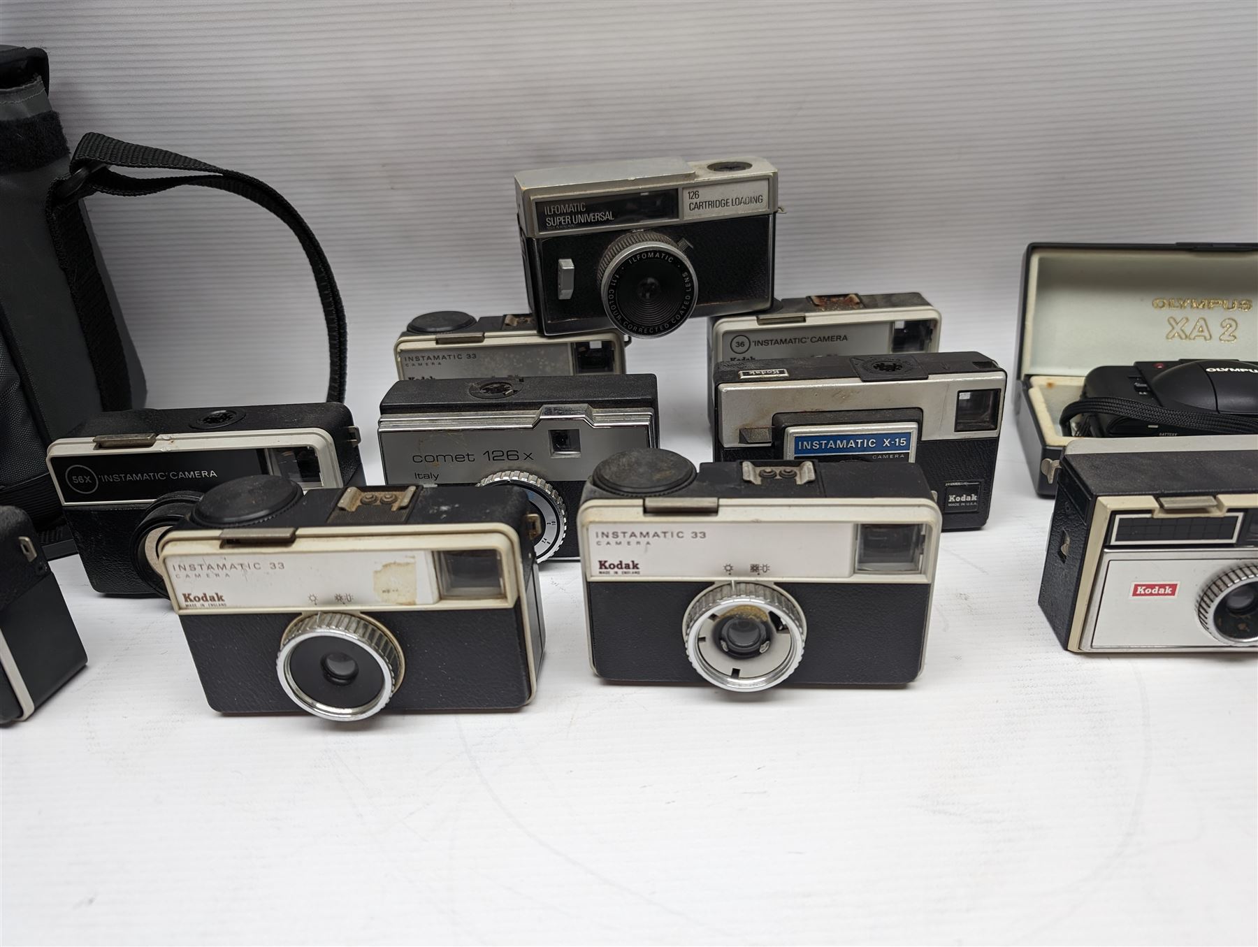Canon EOS 650 camera, serial no 2122736, in carry case with some accessories, together with an Olympus XA2 camera and ten Kodak Instamatic cameras and two similar