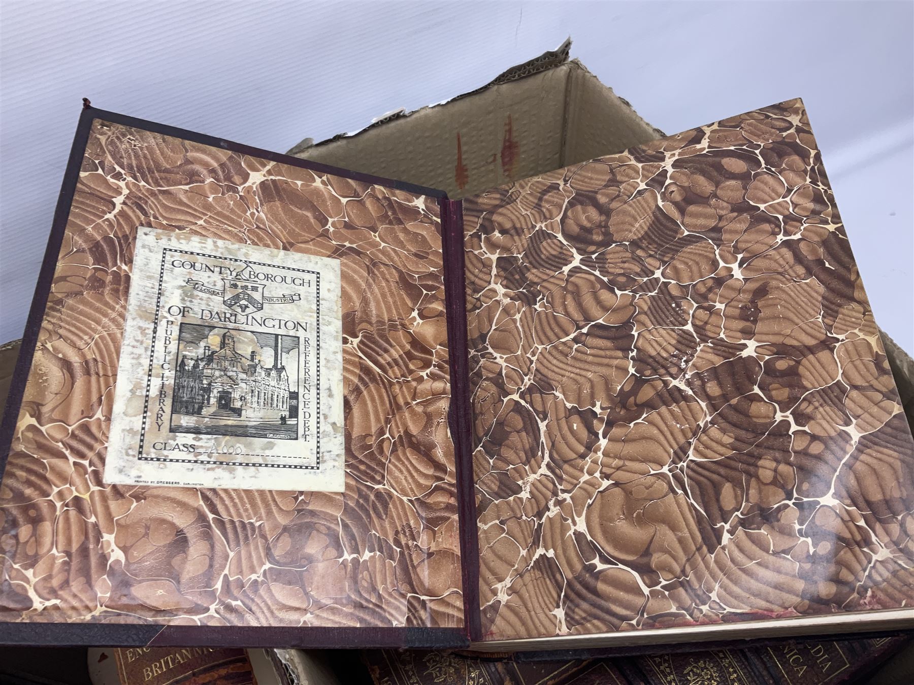 Thirty six volumes of Encyclopaedia Britannica with gold tooled red leather spines in various editions 