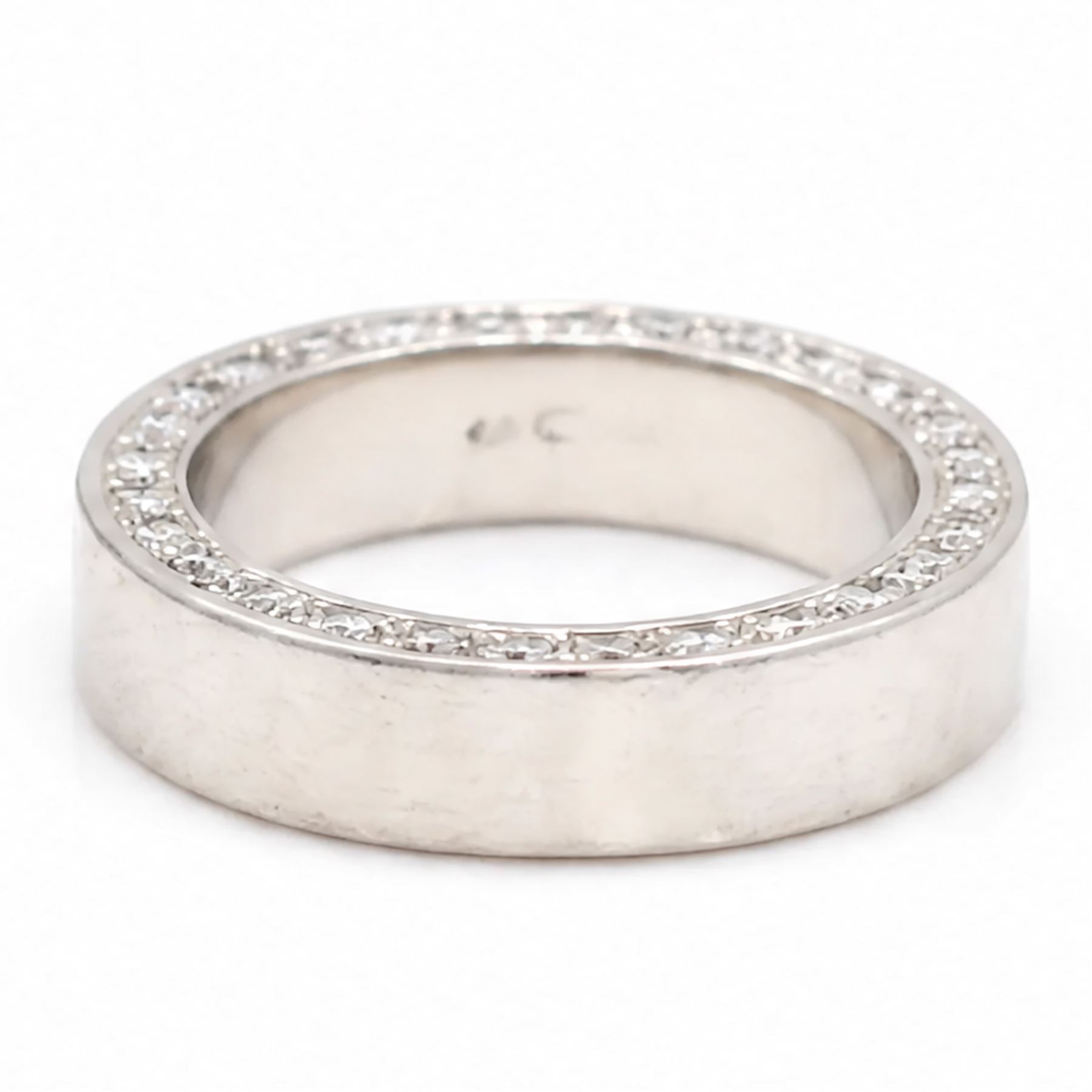 Platinum diamond wedding band, each side set with twenty-eight round brilliant cut diamonds, Sheffield 2000, total diamond weight approx 0.55 carat