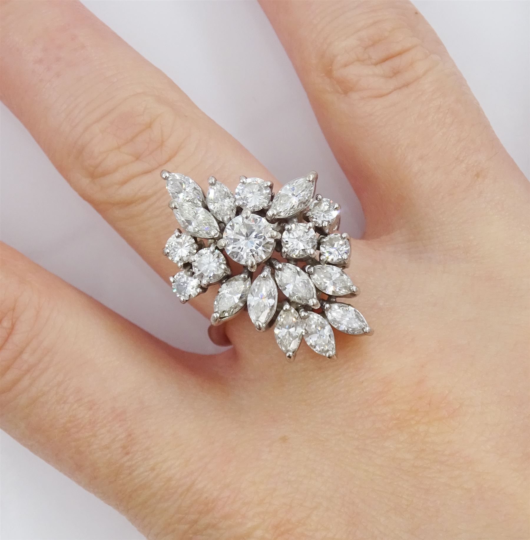 18ct white gold round brilliant cut and marquise cut diamond, stepped design cluster ring, London 1975, total diamond weight approx 3.10 carat