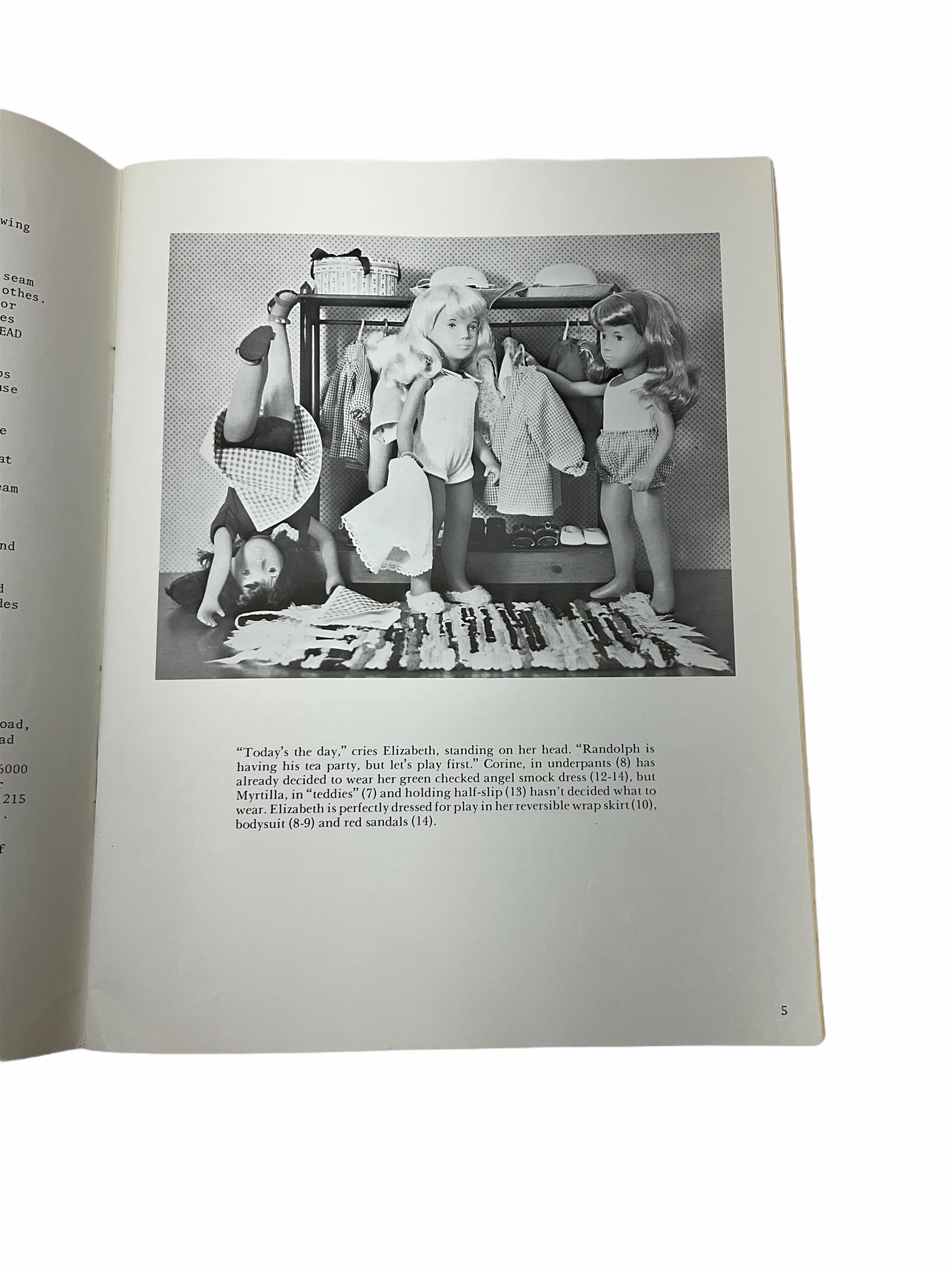 Heidi Ott doll in tartan dress, navy floral dress with white lace and ribbon detailing, striped blue and white dress and a 'Head to Toe' book