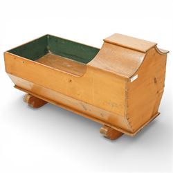 Victorian pine crib, of elongated rectangular form with raised hooded head end, painted interior, panelled sides and raised on a rocker base