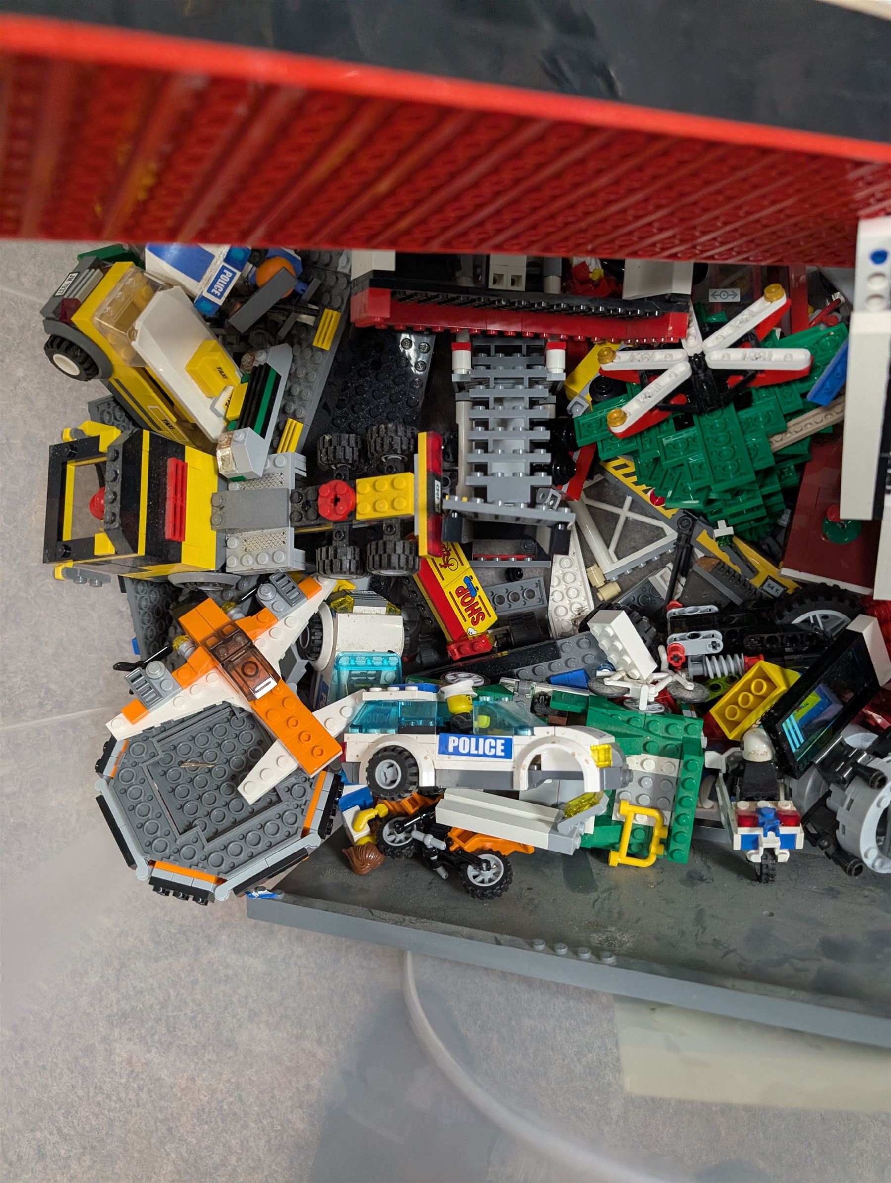 Two boxes of partially built Lego vehicles, including Lego Technics Dumper Truck no. 8264, Titanic, container ships, police boat, smaller police vehicles, etc