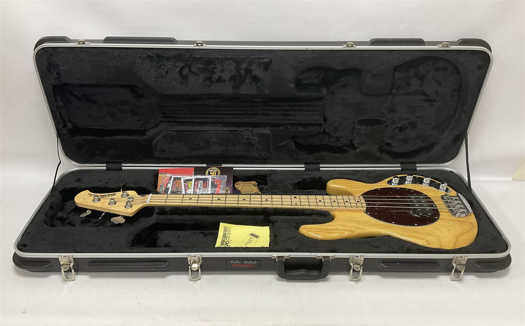 Ernie Ball Music Man Sting Ray 4 string bass guitar, in natural finish with roasted maple neck and tortoiseshell effect scratch guard, serial no 87485, in black Music Man hard case, guitar L114cm