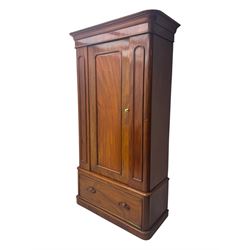 Large Victorian mahogany wardrobe, projecting moulded cornice over single panelled door enclosing hanging hooks and sliding rail, the base fitted with full width drawer, on plinth base

