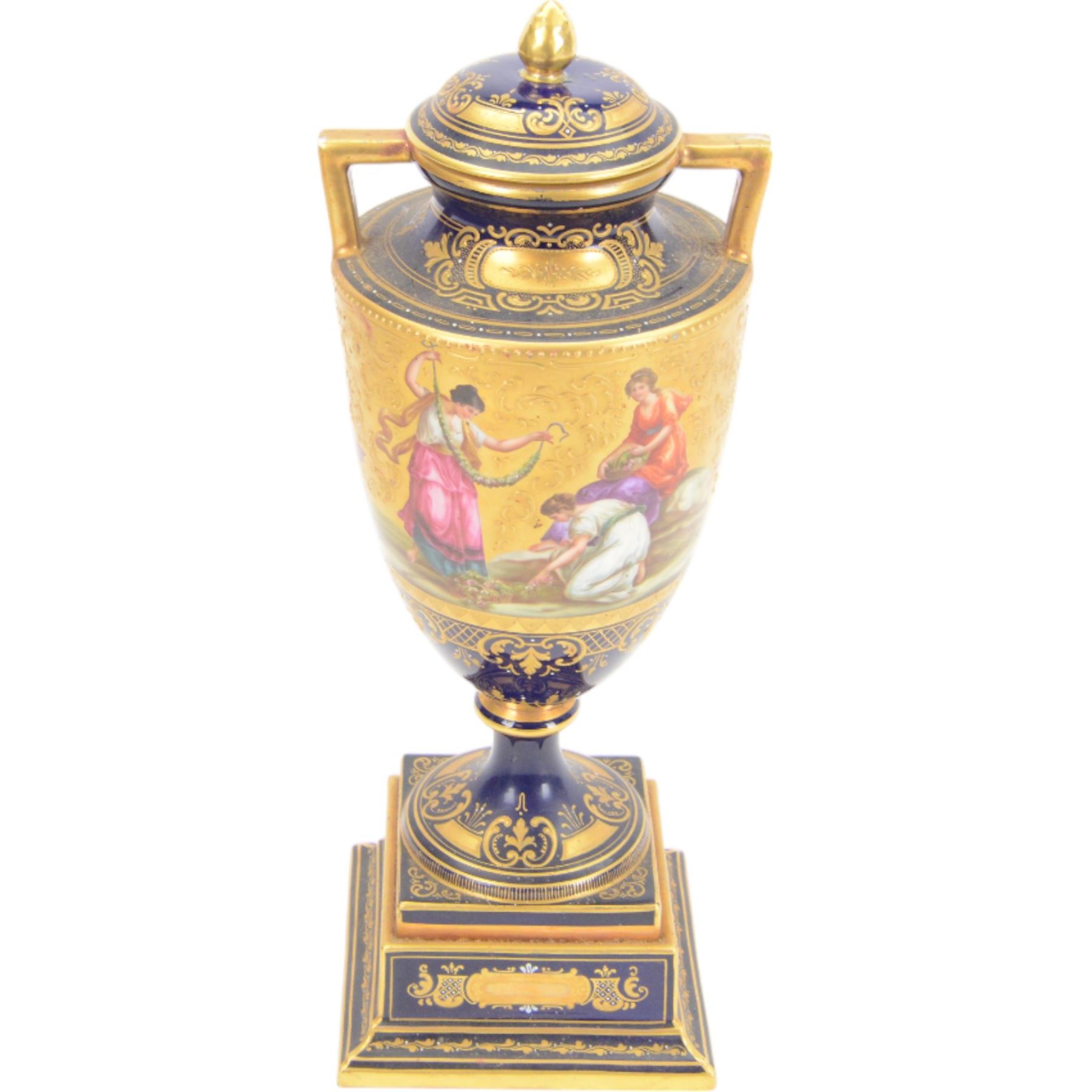 Late 19th century Vienna twin handled urn and cover decorated with classical figures on a textured gilt ground,  upon a square stepped cobalt blue pedestal with gilt detailing, H36cm
