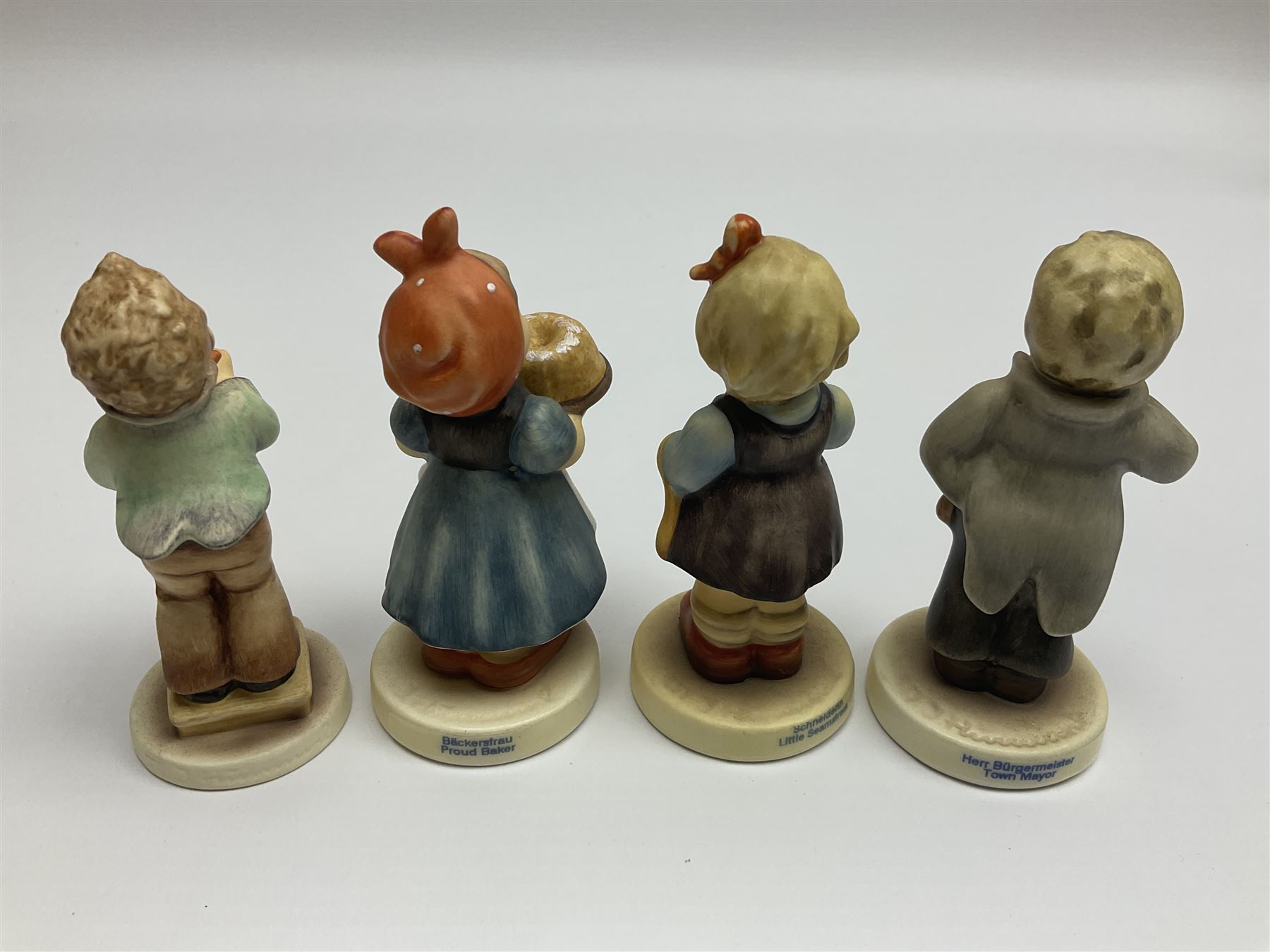 Thirty Hummel figures by Goebel, to include Saluting the Peacekeepers of Operation Joint Endeavor, on wooden plinth, Call to Glory, Celebrate with Song and Soldier Boy