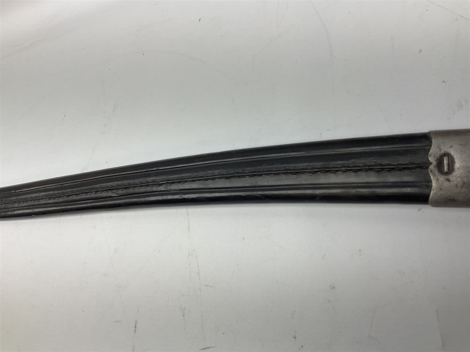 Turkish Model 1874 sword bayonet with 57.5cm curving steel fullered blade and chequered black grip, in steel mounted leather scabbard L75.5cm overall