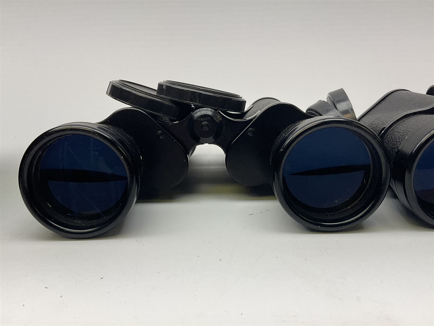Two pairs of binoculars, Stellar binoculars in case and Tasco binoculars model 306 in case. 