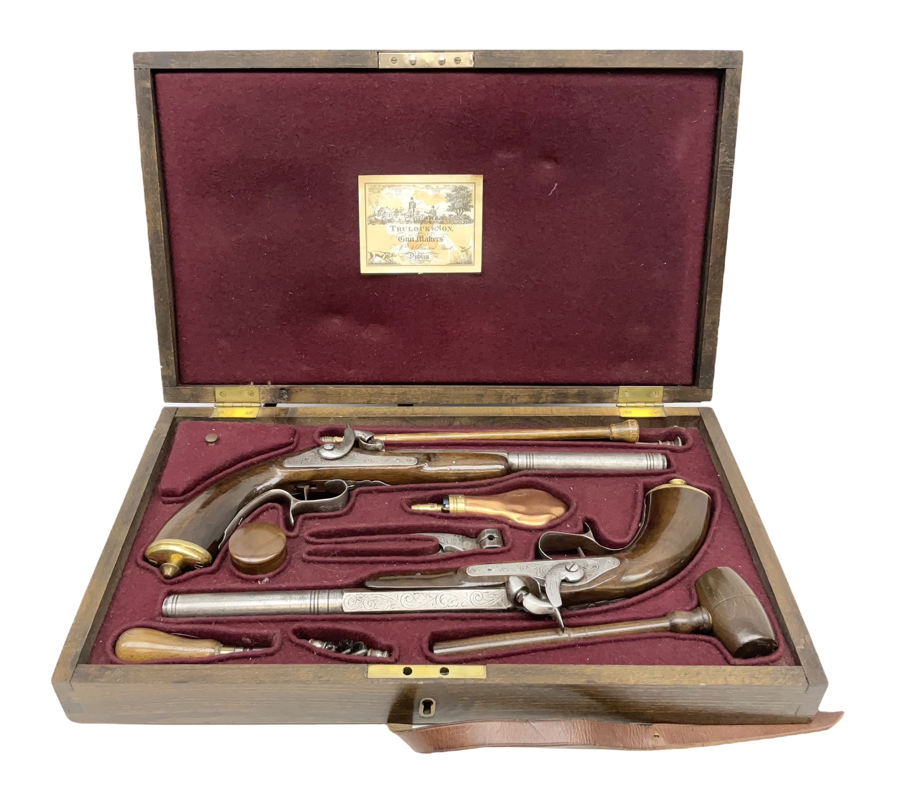 SECTION 1 FIREARMS CERTIFICATE REQUIRED OR REGISTERED FIREARMS DEALER - Pair of Reproduction Continental .44 calibre percussion target pistols, each with heavy 23.5cm octagonal to round barrel bearing various marks, crude scroll engraving to lock plate, hammer and octagonal section of barrel, unchequered walnut stock with brass butt plate and steel hooked trigger guard, numbered 8138 & 8164, L41.5cm overall; in maroon baize lined converted sapele mahogany fitted case bearing reproduction trade label for Trulock & Son Dublin containing small copper powder flask, steel scissor action bullet mould, nipple key, turned wooden mallet and lidded box, steel rammer and wooden cleaning rod, case L48cm