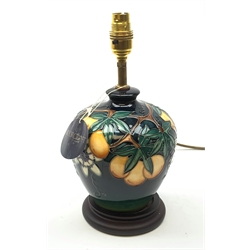 A Moorcroft table lamp, in the Passion Fruit pattern, designed by Rachel Bishop, raised upon a stepped circular base, including fixtures H9.5cm. 