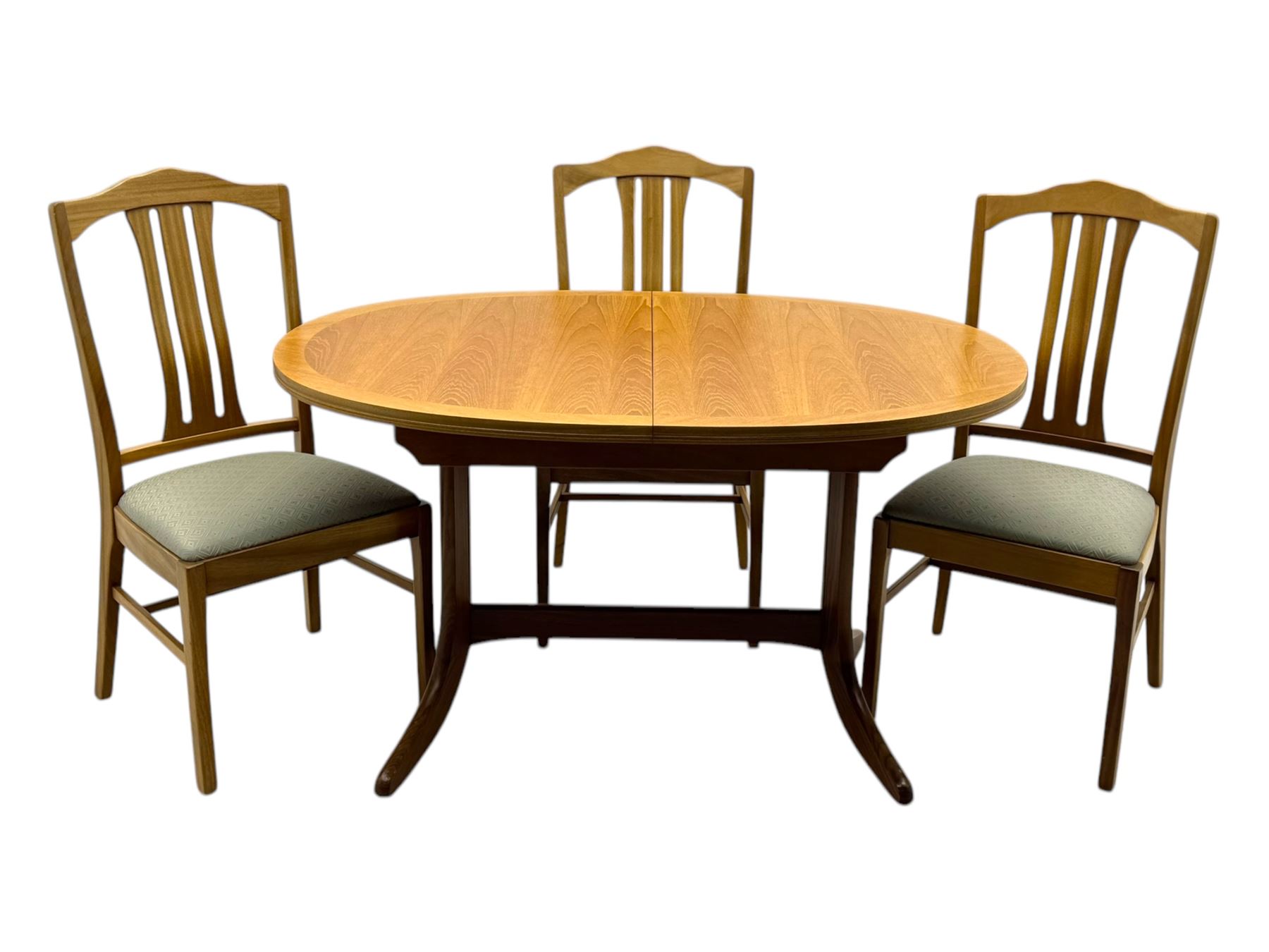 G-Plan - mid-20th century teak extending dining table, oval top with concealed central butterfly leaf extension, raised on splayed supports with cross-stretcher; three dining chairs with curved top rail and vertical splats