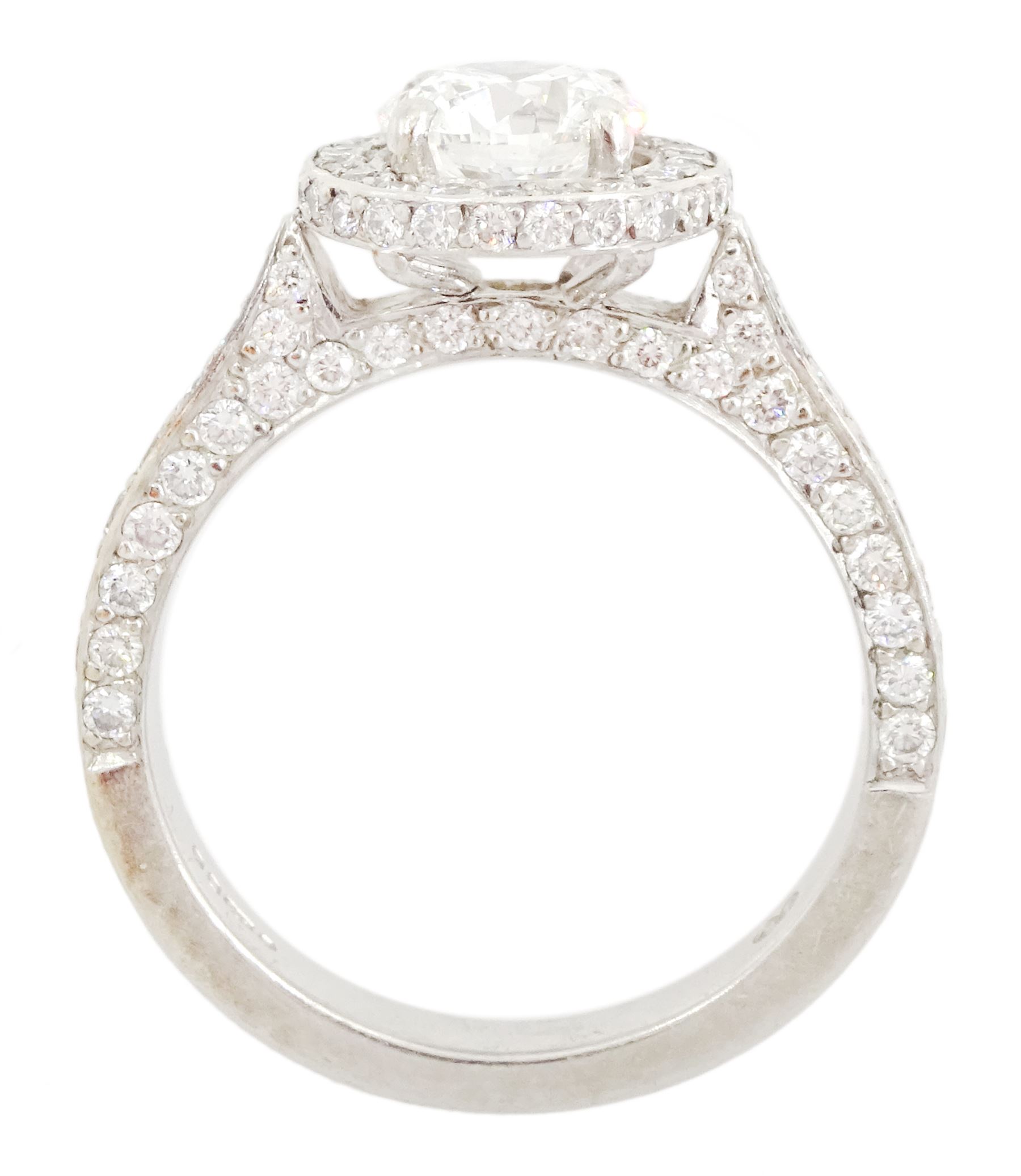 Platinum round brilliant cut diamond cluster ring, the principal diamond of approx 1.05 carat, with diamond surround and shoulders, London 2009, total diamond weight approx 1.65 carat
