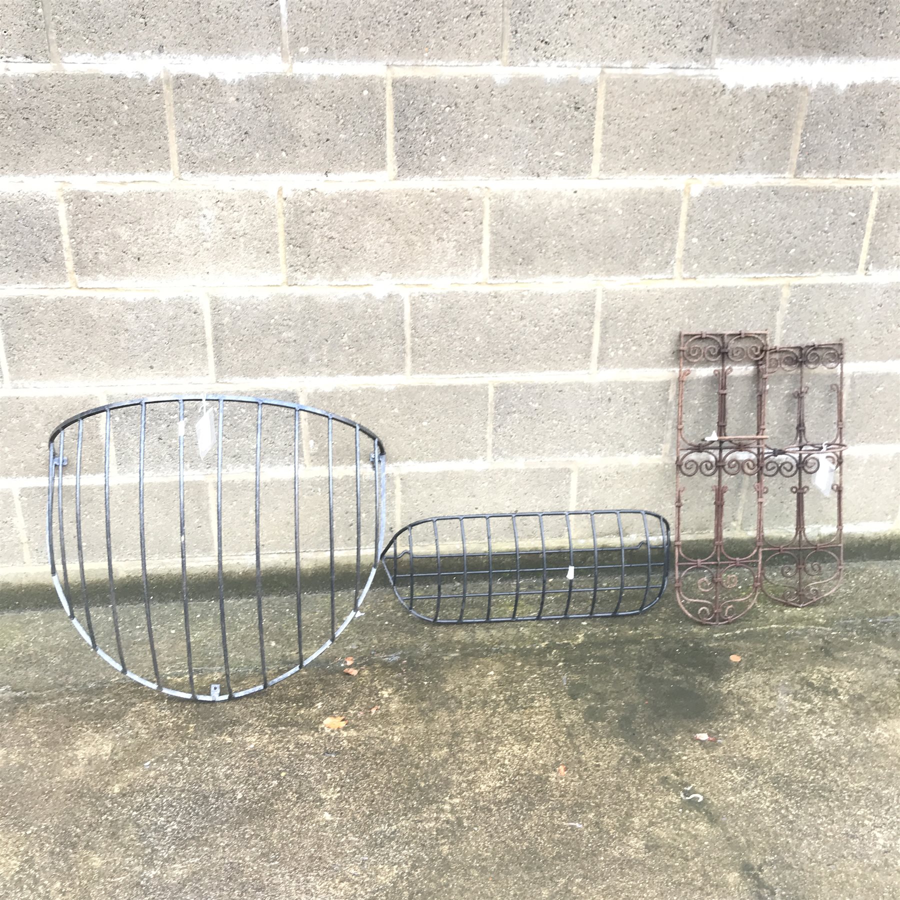 Wrought metal weather vane with hunting scene pediment, H165cm (overall) a hay rack, flower rack and two wall holders 
