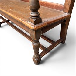 Early 20th century pine and oak bench seat, stained pine rail back frame with shaped oak arms