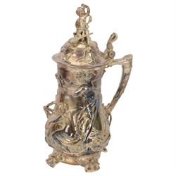 Large late 19th/early 20th century WMF Art Nouveau silver plated stein or jug, circa 1900, the bellied body cast and applied with Bacchanalian figures, the domed cover with putti finial, and handle modelled as a vine, the whole upon four fruit and leaf mounted feet, marked beneath for WMF and engraved with initials CHE and dated 1911, H40.5cm
