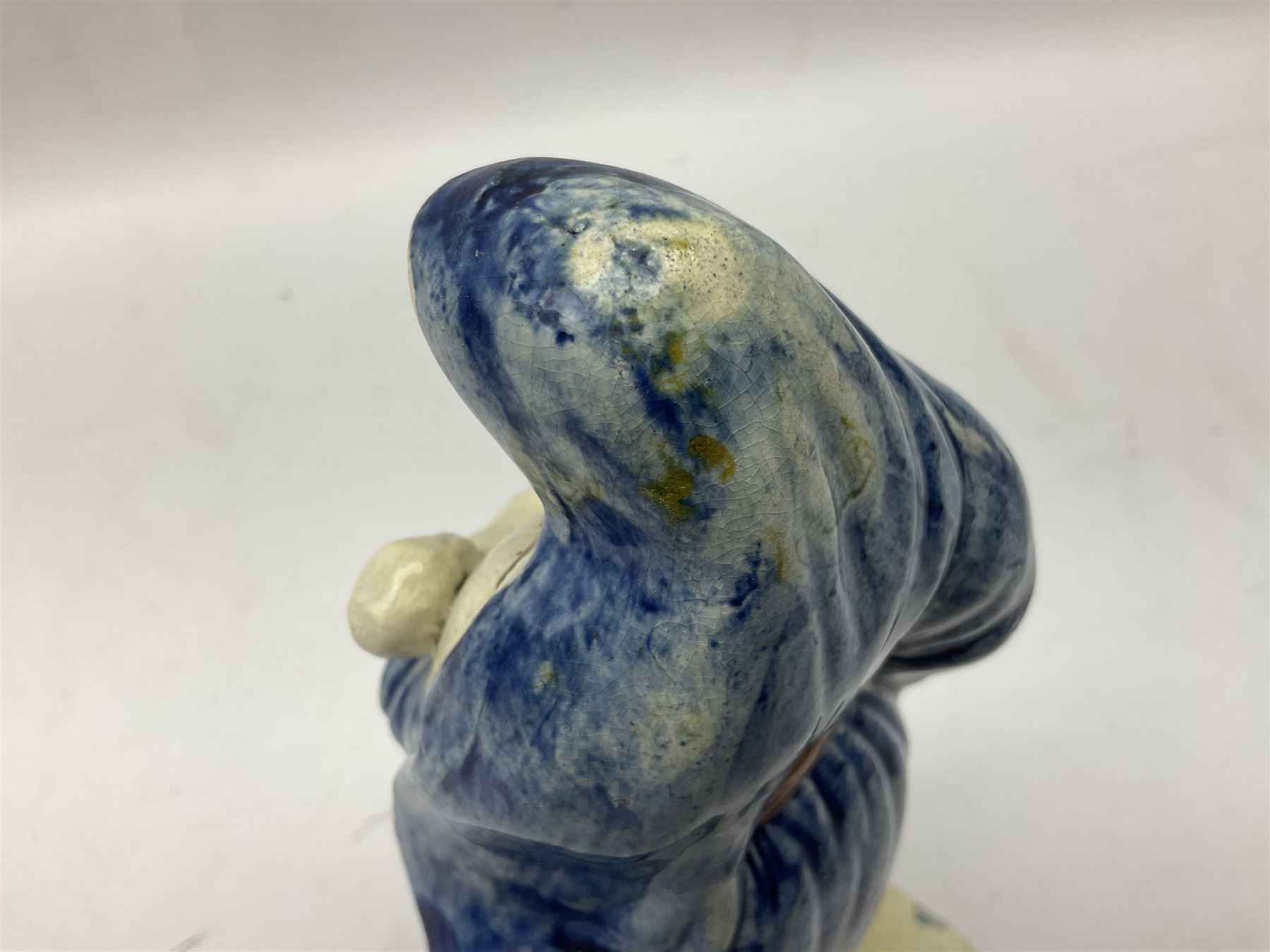 Late 18th century Prattware figure representing Charity, modelled as a mother with baby in her arms and two small children clutching at her robes, upon a square base, overall H21cm.