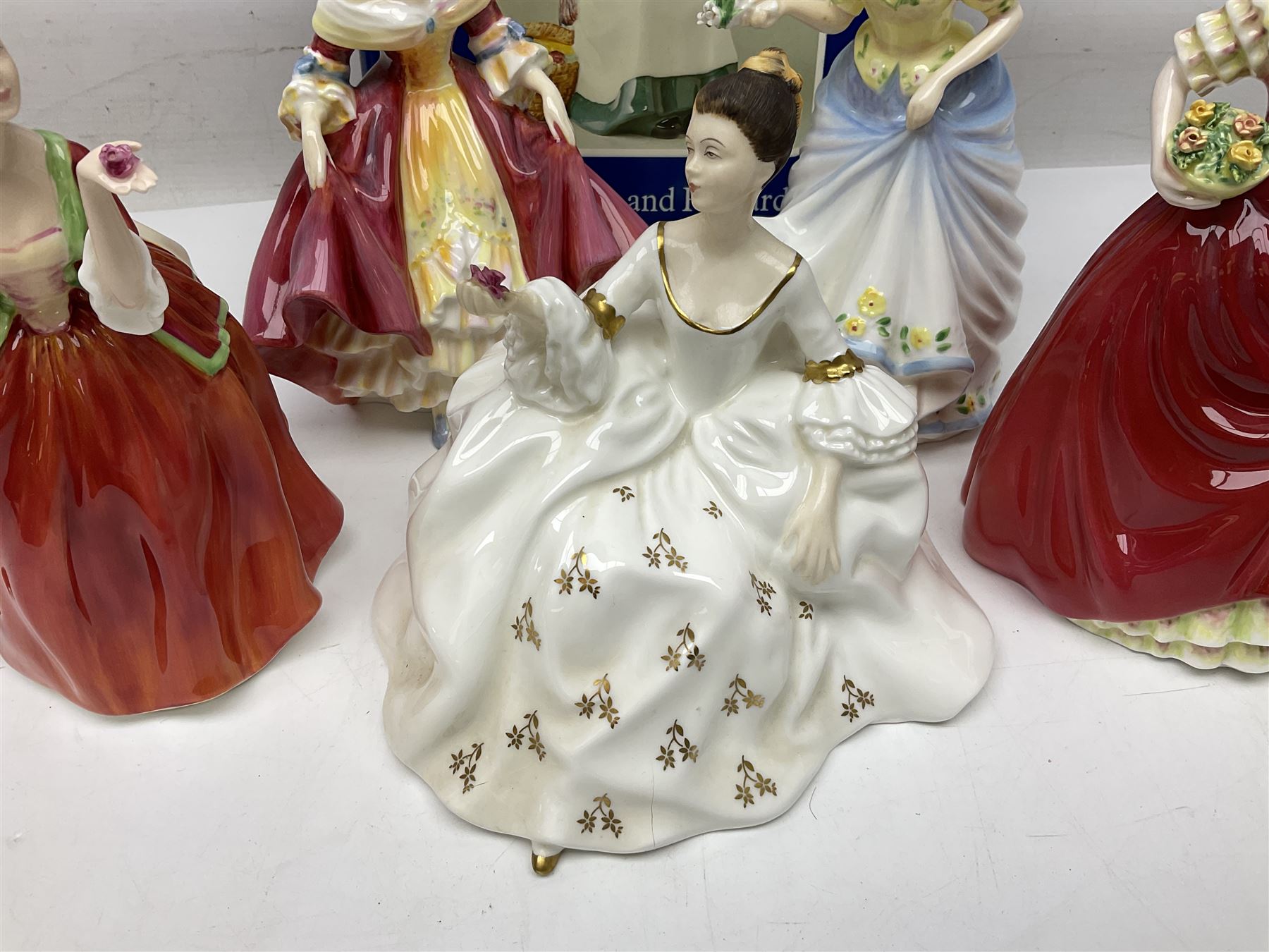 Five Royal Doulton figures, comprising Flower of Love HN3970, Emily HN3688, Southern Belle HN2229, Helen HN3886 and My Love HN2339, all with printed mark beneath, some with boxes, together with a Royal Doulton Figures reference book by D Eyles and R Dennis