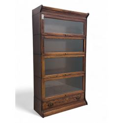 Early 20th century oak stacking library bookcase, four sections enclosed by hinged and sliding glazed doors, fitted with single drawer 