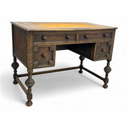 Early 20th century Jacobean design oak desk, with rectangular top inset with worn tooled leather, two frieze drawers over pedestals each fitted with a pair of panelled drawers, turned handles, on carved and fluted tapering legs united by stretchers 