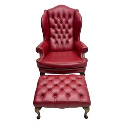 Kingsgate - contemporary 'Queen Anne' wingback armchair with matching stool, high back with deep button tufting, upholstered in red leather with brass stud trim, on carved cabriole supports