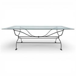 Late 20th century glass dining table, toughened glass top with rounded corners on a wrought metal designed base 