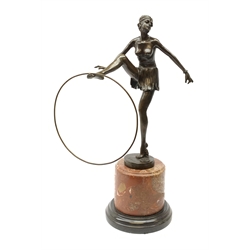 An Art Deco style bronze after D Alonzo, modelled as a female hoop dancer, with impressed mark and foundry mark, raised upon a cylindrical marble base, overall H47cm. 