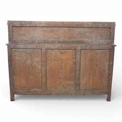 Victorian carved oak sideboard, the rectangular top with raised back carved with foliate scrolls and scroll end supports, upon a base with rectangular top with moulded edge, pair of drawers with conforming carved decoration and mask handles, and pair of carved cupboard doors, upon short stile type feet H101.5cm W183cm D54cm 