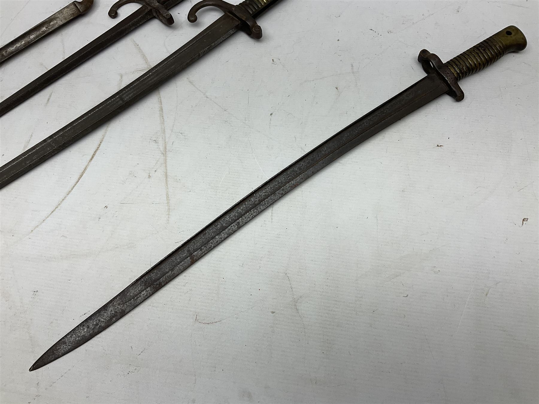 Five 19th century bayonets in relic condition without scabbards comprising British Pattern 1876 socket bayonet with Indian markings; French Model 1874 epee bayonet; and three French Model 1866 sabre bayonets (5)