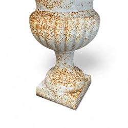 Pair of Victorian design painted cast iron garden urns, egg and dart rim, tapering column on pedestal base