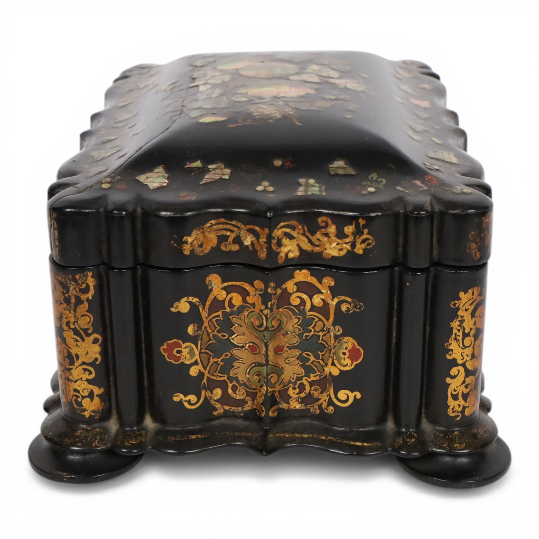 Victorian black lacquered papier-mâché sewing box, of rectangular form with shaped sides, the slightly domed top with inlaid mother of pearl and abalone decoration, the sides with gilt and polychrome painted scrollwork, the hinged cover opening to reveal a fitted interior with lift out tray, H14cm