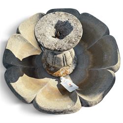 Weathered cast stone garden water feature fountain, the raised central spout with egg-and-dart moulding, within a scalloped basin raised on a lappet pedestal with cylindrical plinth base
