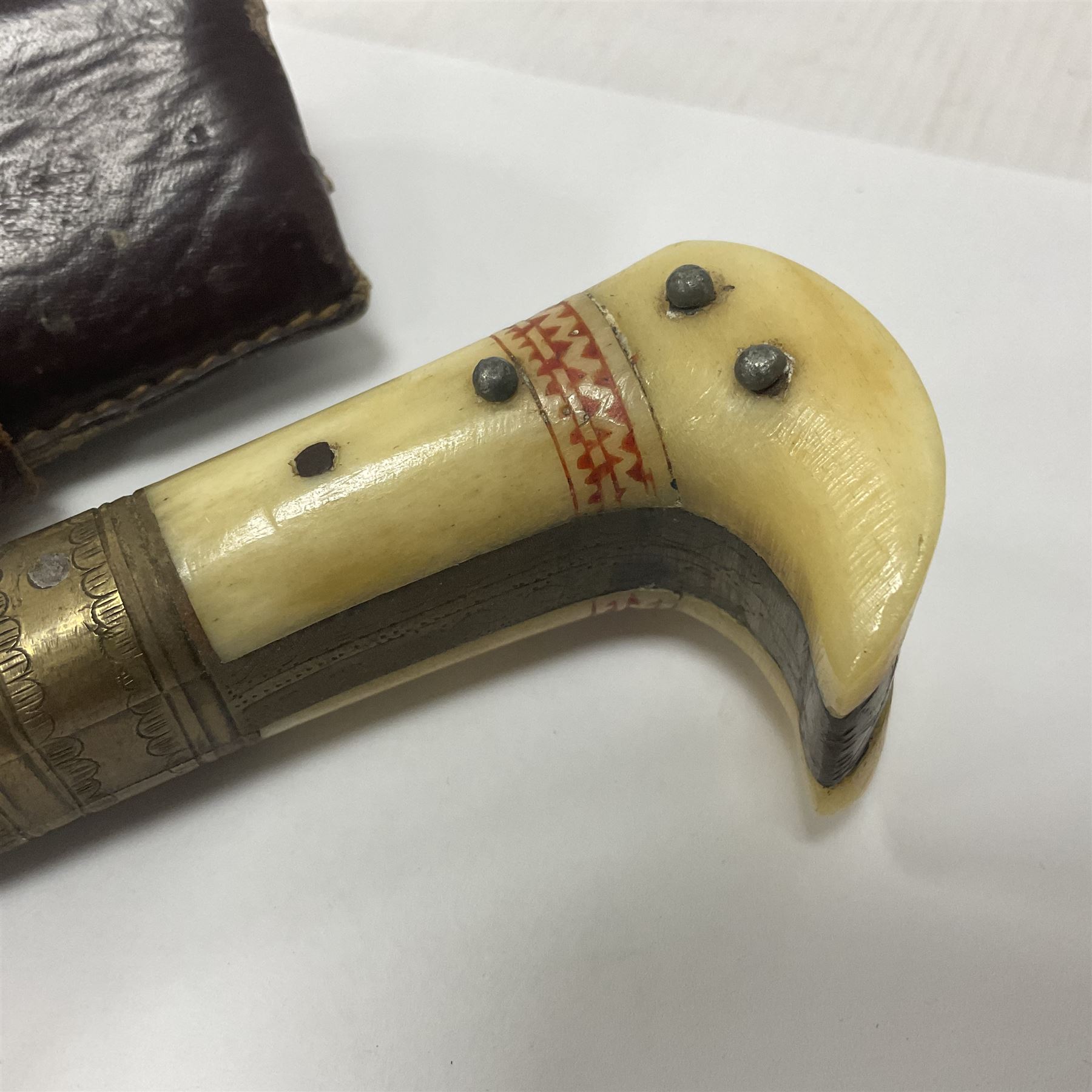 Afghan Khyber knife (Choora), blade engraved along the top edge with ornate brass and bone grip, with leather scabbard, overall L31cm, blade L20cm