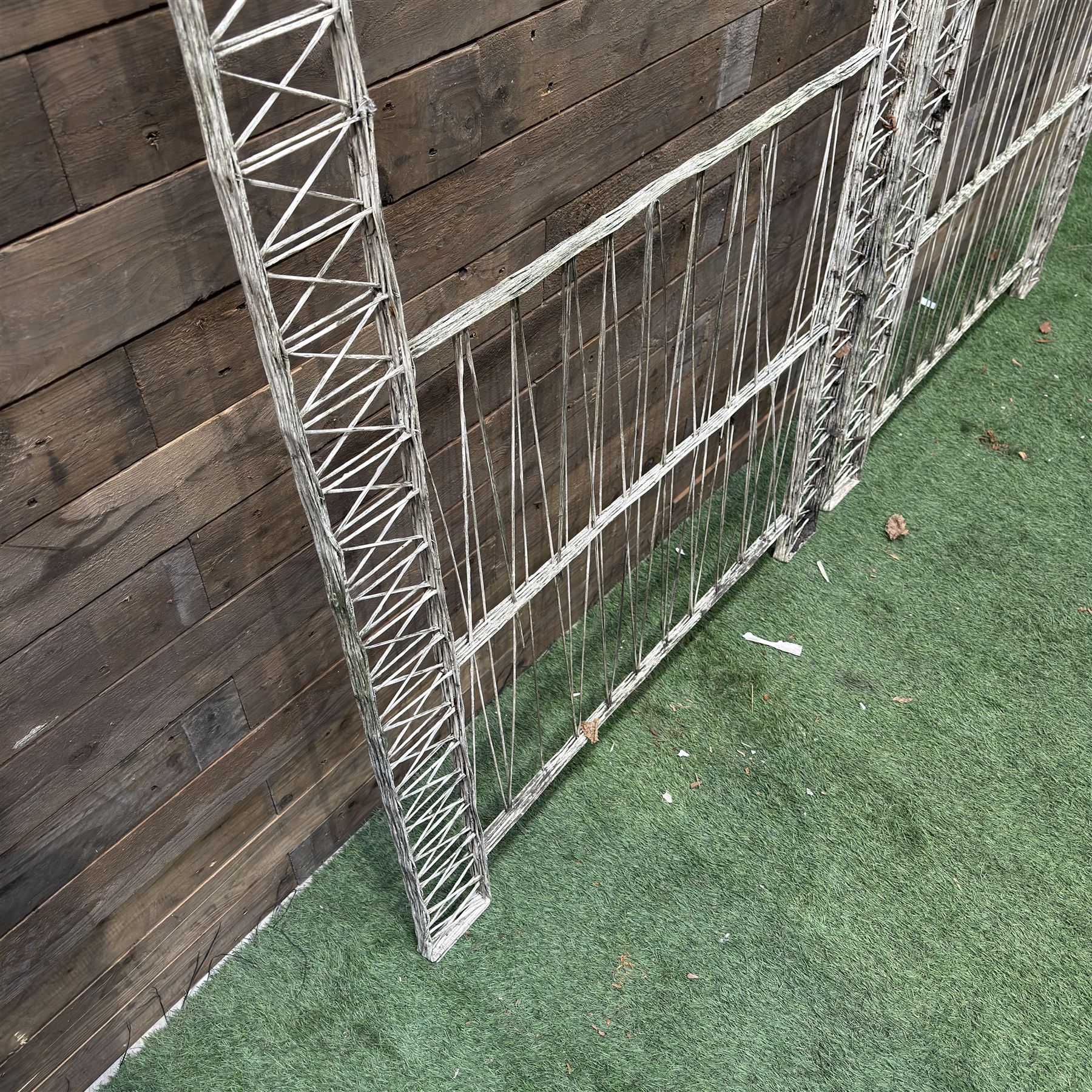Four early 20th century French painted wicker garden trellis or dividers, rectangular form with internal arches