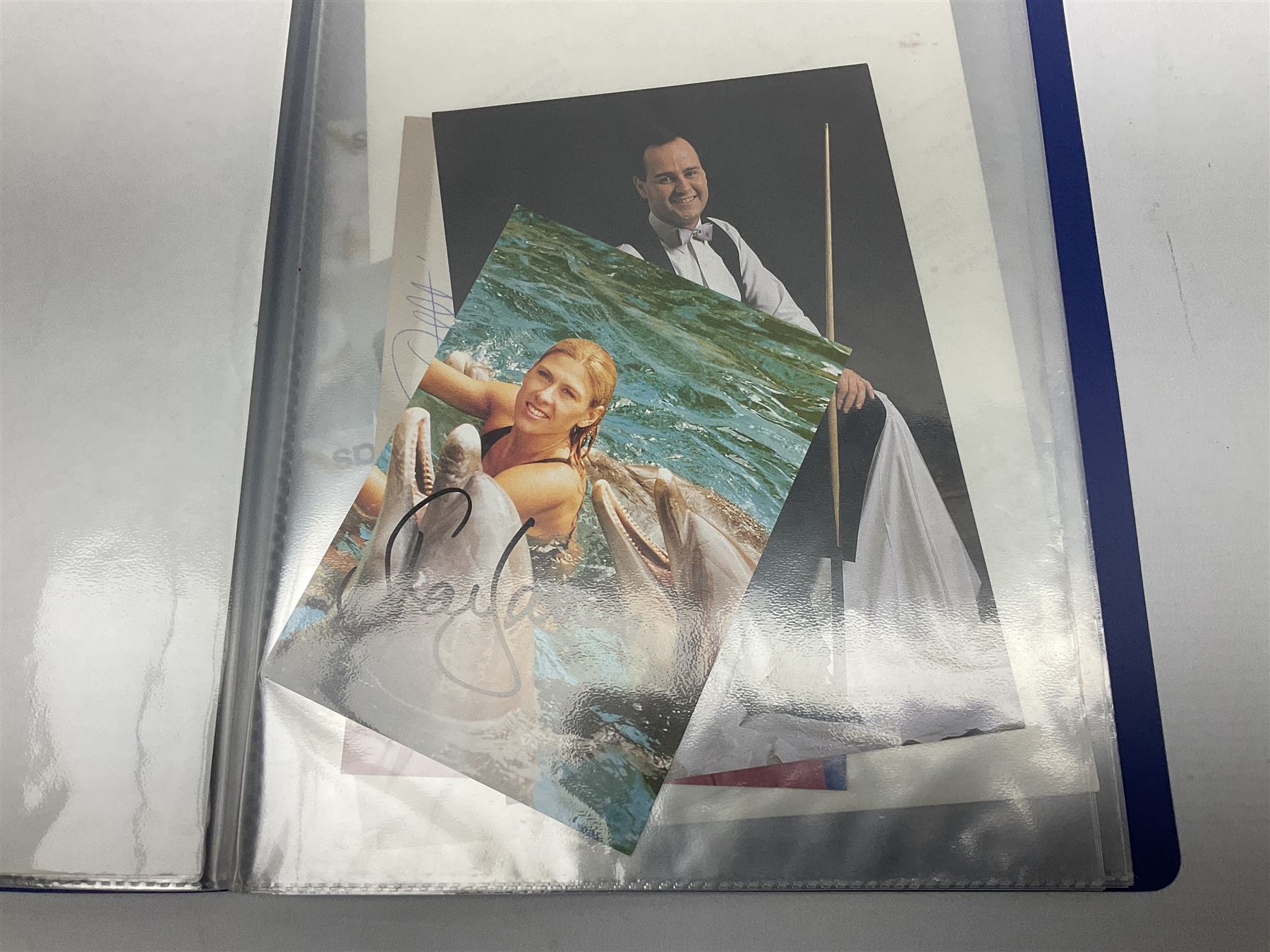 Two folders of over fifty photographs, cards, compliment slips etc of actors, actresses, celebrities, politicians, sports personalities etc, all bearing signatures, including David Frost, Lloyd Grosman, John Suchet, Julia Somerville and othe GMTV presenters, Carol Vorderman, Jackie Collins, Rolf Harris, Timothy Dalton, Pete Postlethwaite, Magnus magnusson, John Major, Kate Moss, Uri Geller, David Beckham, Peter Alliss, Sharon Davies, Kevin Keegan etc