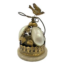 Victorian evening dinner bell, with three mother of pearl shells, floral and grape gilt decoration, and bird finial, raised upon a circular soapstone base with gilt pierced gallery, H14cm