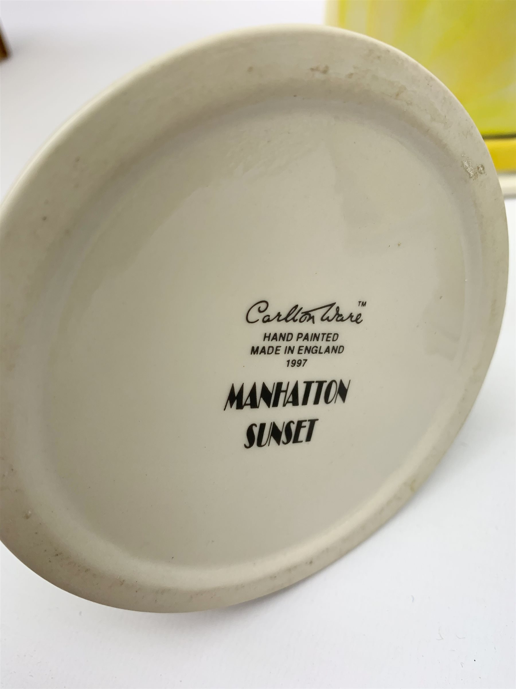 A Carlton Ware Art Deco style coffee set, decorated in the 'Manhatton Sunset' pattern, comprising coffee pot, milk jug, open sucrier, and six coffee cans, all of tapering form, coffee pot H26.5cm. 