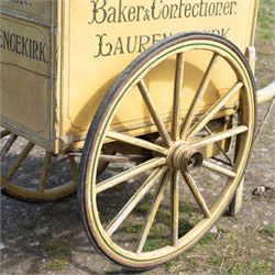 James I. Douglas, Baker & Confectioner, Laurencekirk Hand Drawn Delivery Cart

An attractive late 19th or early 20th century hand drawn baker's delivery cart, finished in cream and retaining its original hand painted advertising livery for James I. Douglas, Baker & Confectioner, Laurencekirk. The enclosed body features a curved roof with external luggage rail, rear access doors and internal shelving for the transport and delivery of bread, cakes and confectionery. Mounted on large wooden spoked wheels with iron tyres and fitted with shaped shafts for a single horse, this is a highly decorative and increasingly scarce example of a provincial tradesman's delivery vehicle, offering excellent display potential for collectors, museums, period interiors or commercial settings.

Features:
• Original hand painted signwriting for James I. Douglas, Baker & Confectioner, Laurencekirk
• Enclosed delivery body with curved roof and external luggage rail
• Rear opening access doors with internal storage compartments
• Original internal wooden shelving and racks
• Large wooden spoked wheels with iron tyres
• Shaped shafts for single horse traction
• Builder's mark for Geo. Roberson Ltd., Wallington
• Decorative cream painted finish with period lining and detailing
• Suitable as a display piece, museum exhibit or advertising feature

Dimensions:
Overall length: 170 cm
Body length: 104 cm
Width: 83 cm
Height: 150 cm

Wheel Diameter:
Wheels: 95 cm