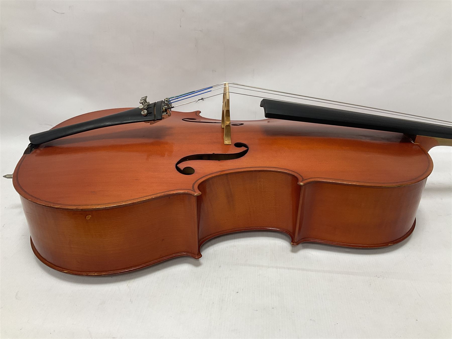3/4 size cello with soft case, 69cm back length, 114cm full length, with bridge, ebonised tail piece and fingerboard.