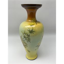 A Doulton Lambeth vase, of baluster form with flared rim decorated with white flowers upon a yellow ground, with printed, impressed and painted marks beneath, H35cm.