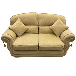 Three piece lounge suite upholstered in beige plain and embossed fabric, comprising two seat sofa and pair of armchairs