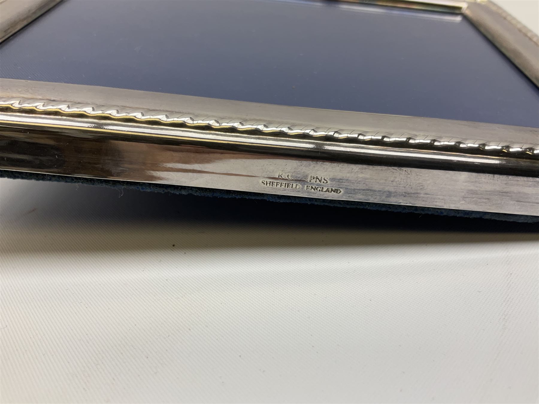 Set of six 1960's silver coffee spoons, hallmarked Sheffield, contained within a fitted case with interior inscribed Harrods, together with a silver napkin ring, hallmarked Birmingham, and a silver plated photograph frame, approximate silver weight 68.4 grams